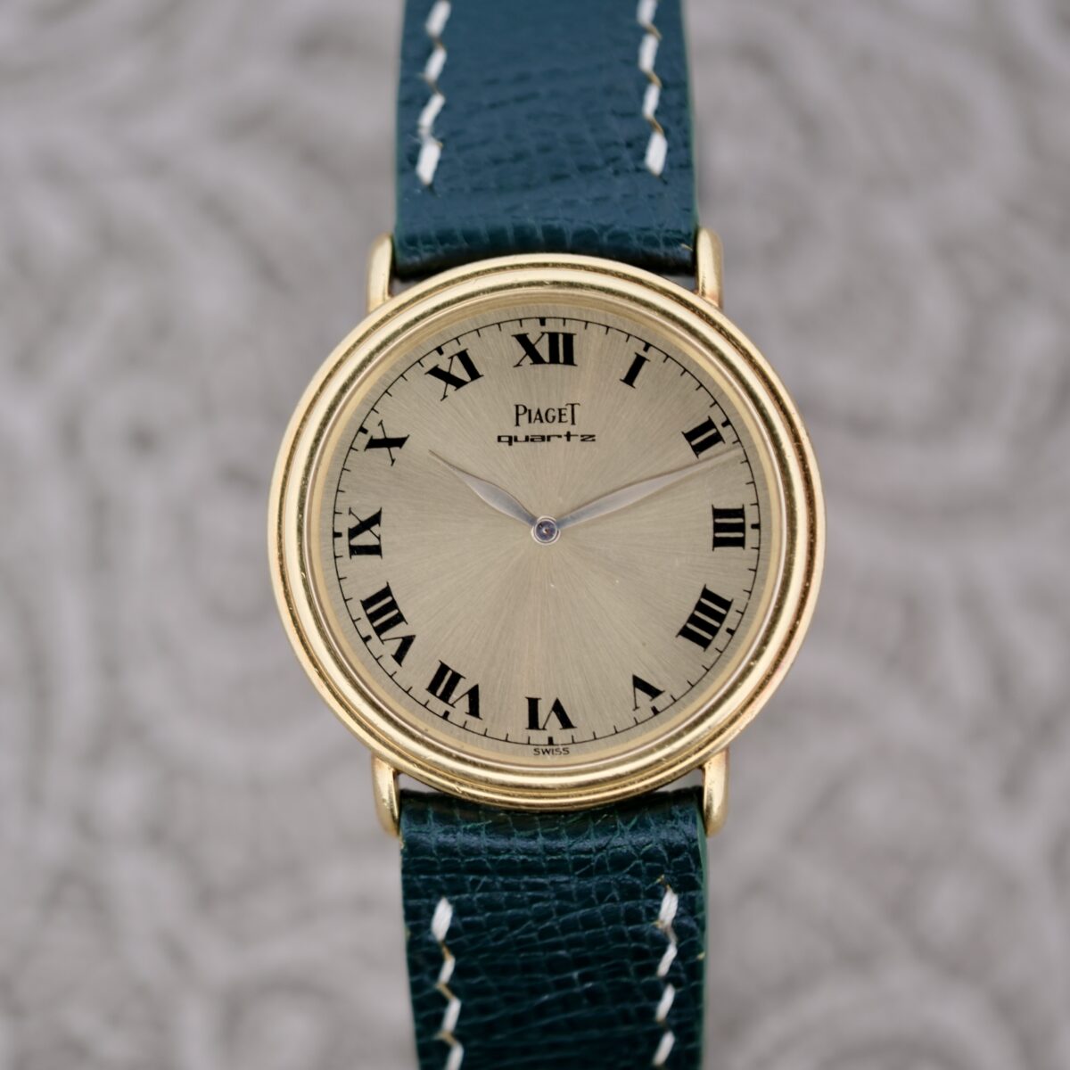 A watch with a green strap